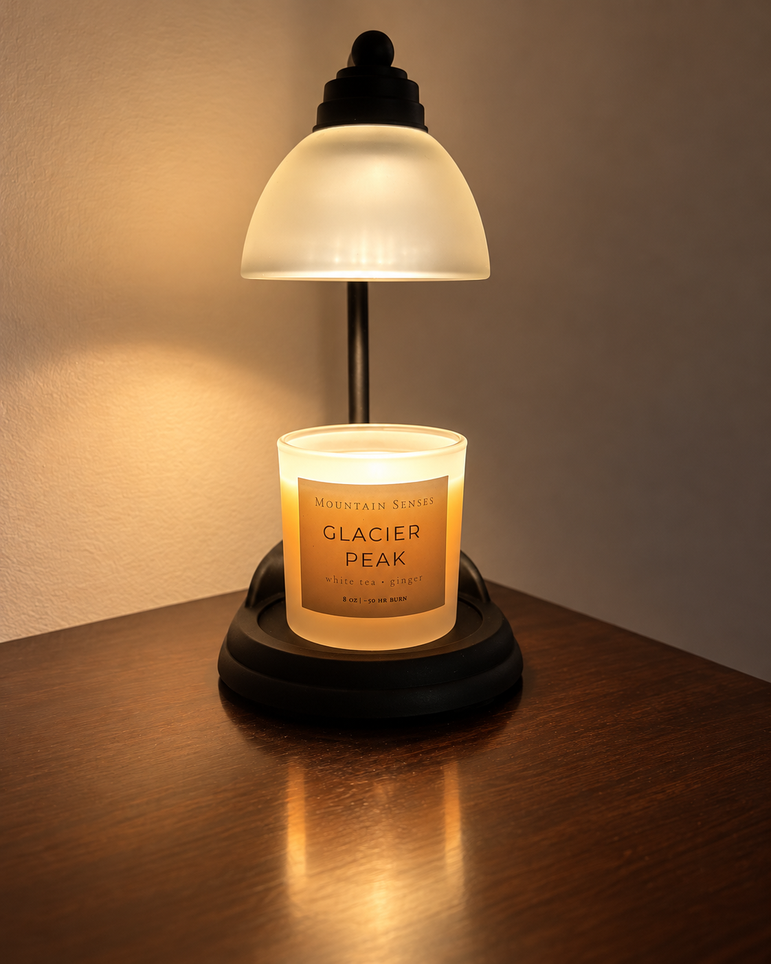 Glacier Peak candle under a glowing candle warmer lamp; warmer not included