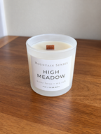 High Meadow 8 oz Ritual Refill candle with unlit wooden wick on a wooden table