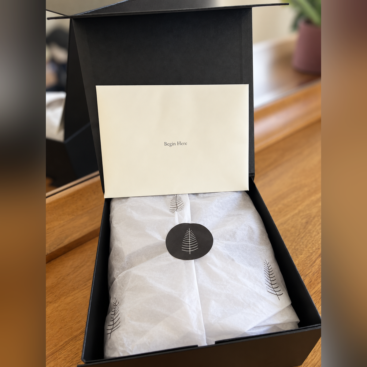 Mountain Senses High Meadow Ritual Box gift presentation with Begin Here envelope and tree-printed tissue wrapping