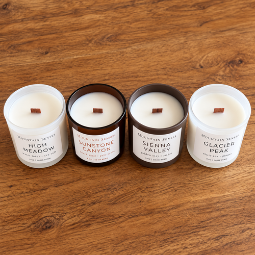 Four Seasons candle collection from above showing all four fragrances and their wooden wicks on a warm wooden table