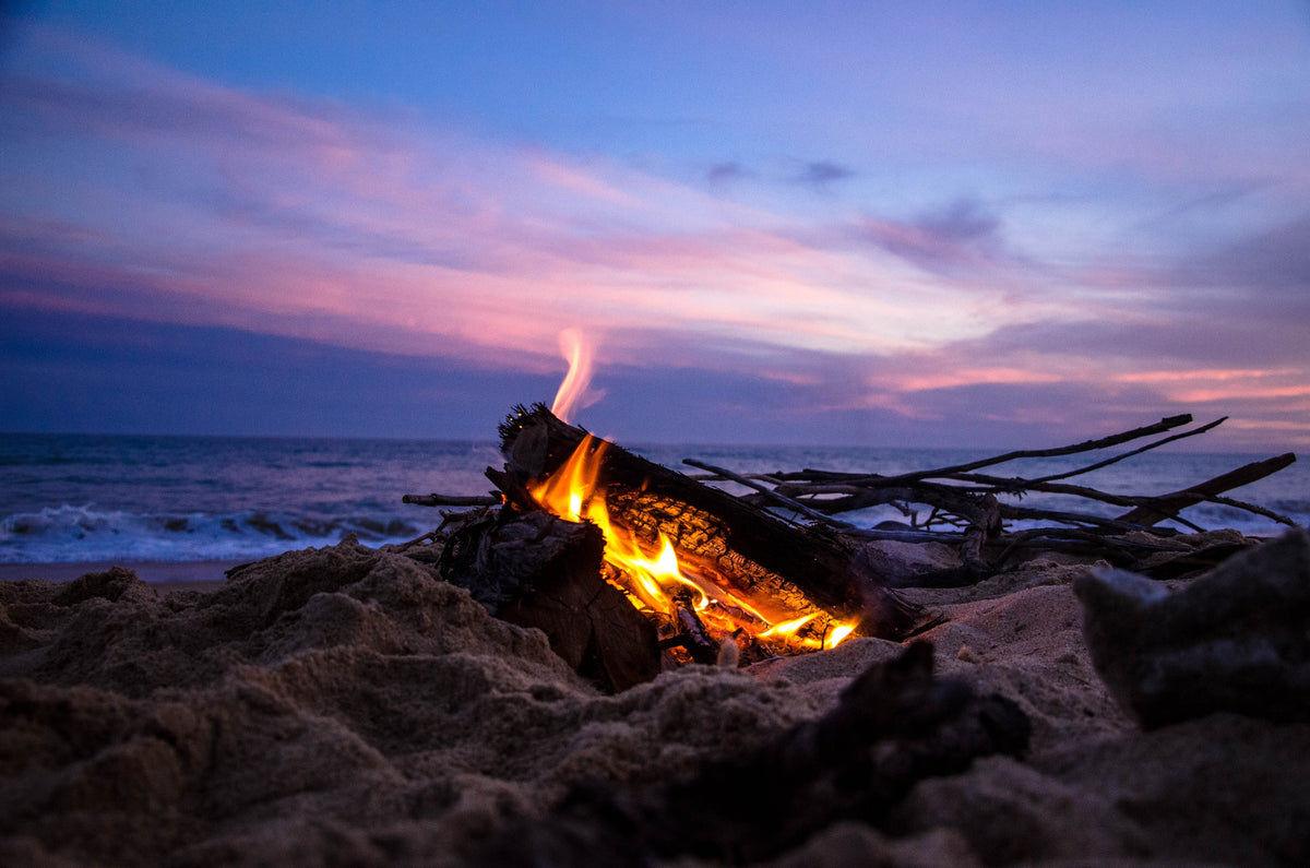The sound of a crackling fire against the ocean tides