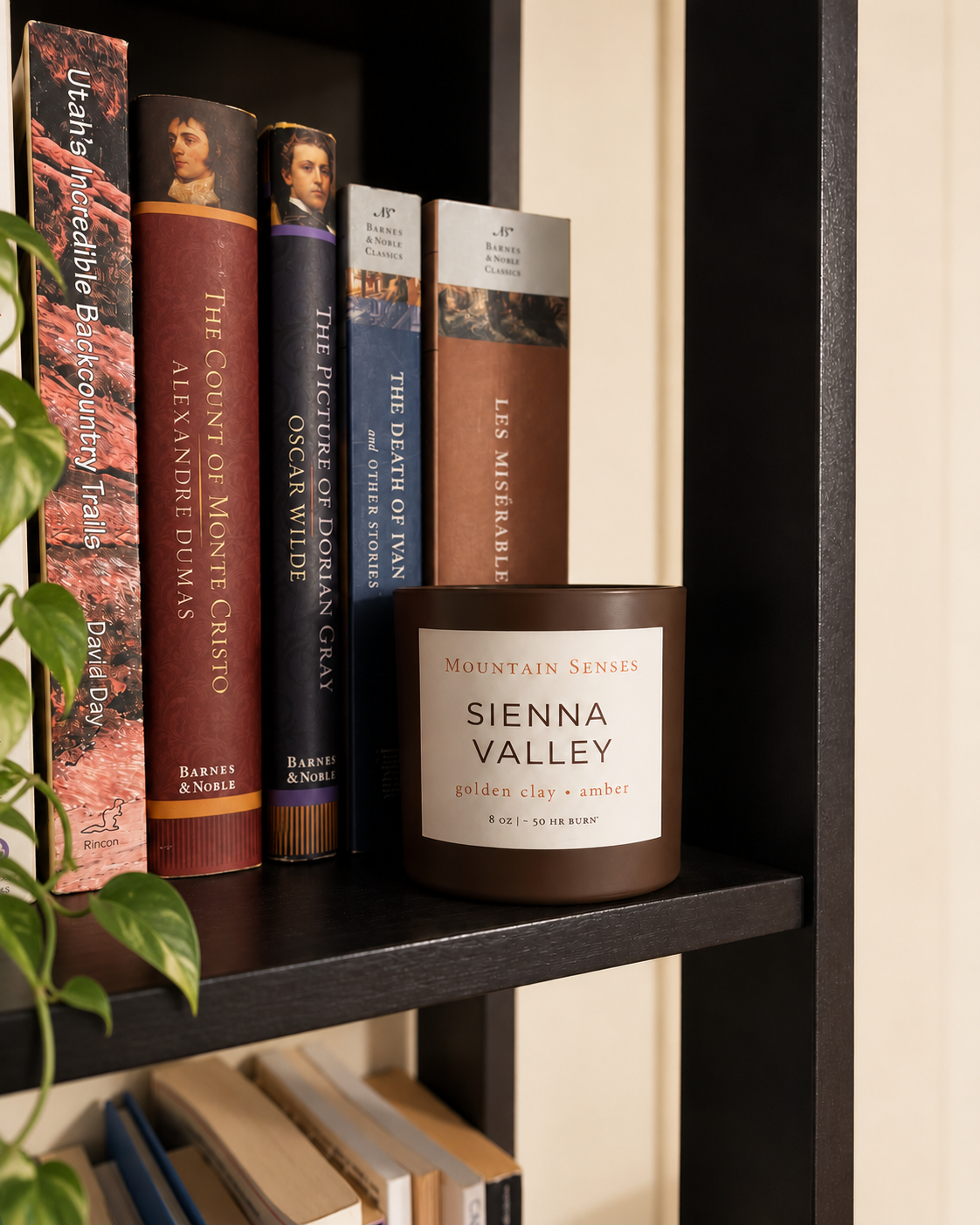Sienna Valley Ritual Refill candle styled on a bookshelf beside classic books
