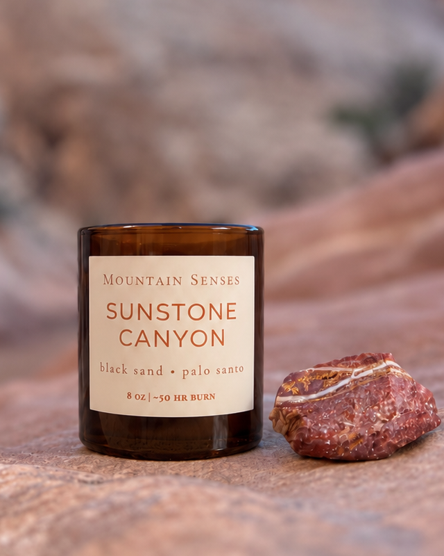 Sunstone Canyon candle and natural red-banded stone photographed in Goblin Valley, Utah