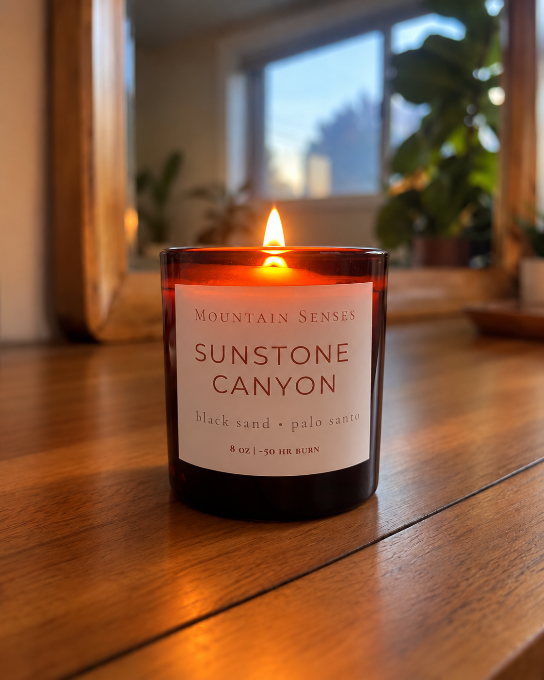 Sunstone Canyon 8 oz Ritual Refill candle with glowing wooden wick on a wooden table